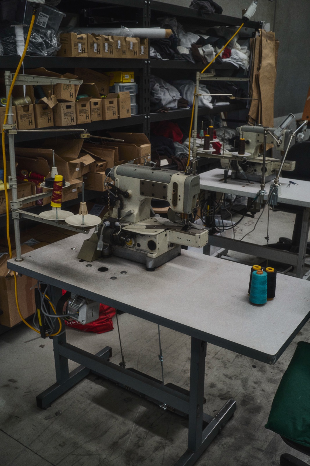 An empty sewing machine station on the factory floor, photographed by Eli Samuel for Australian Stitch.