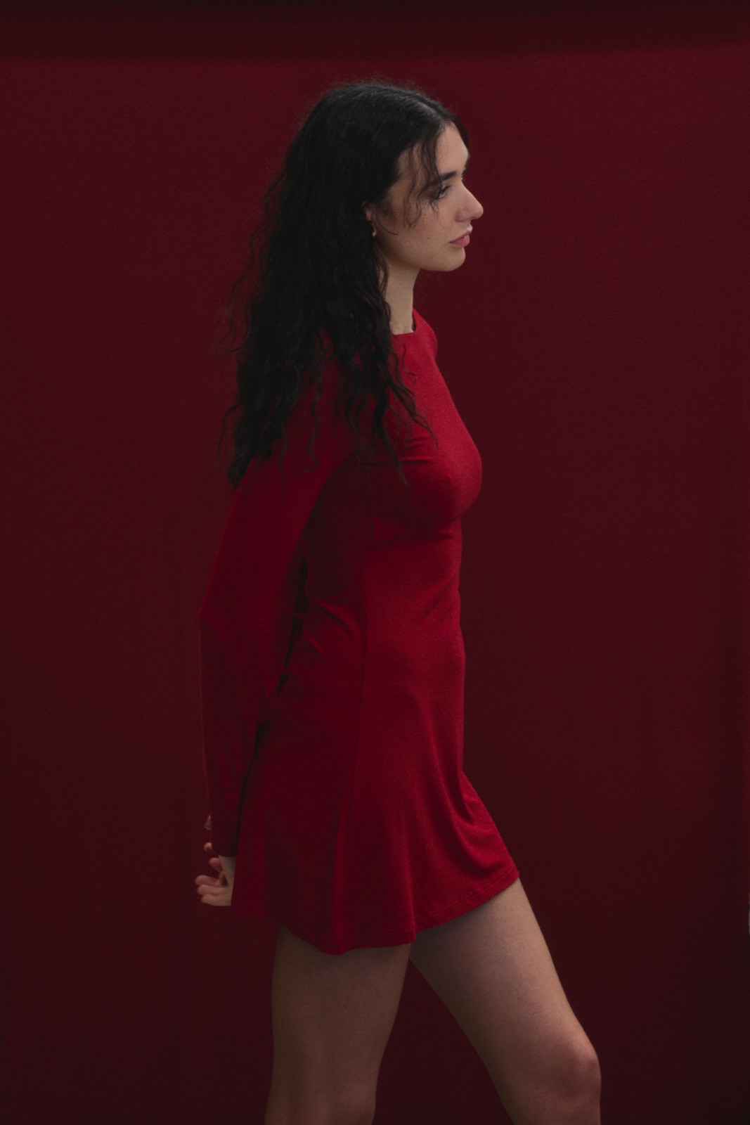 Katja in profile in a red dress against red fabric, photographed by Eli Samuel for Australian Stitch.