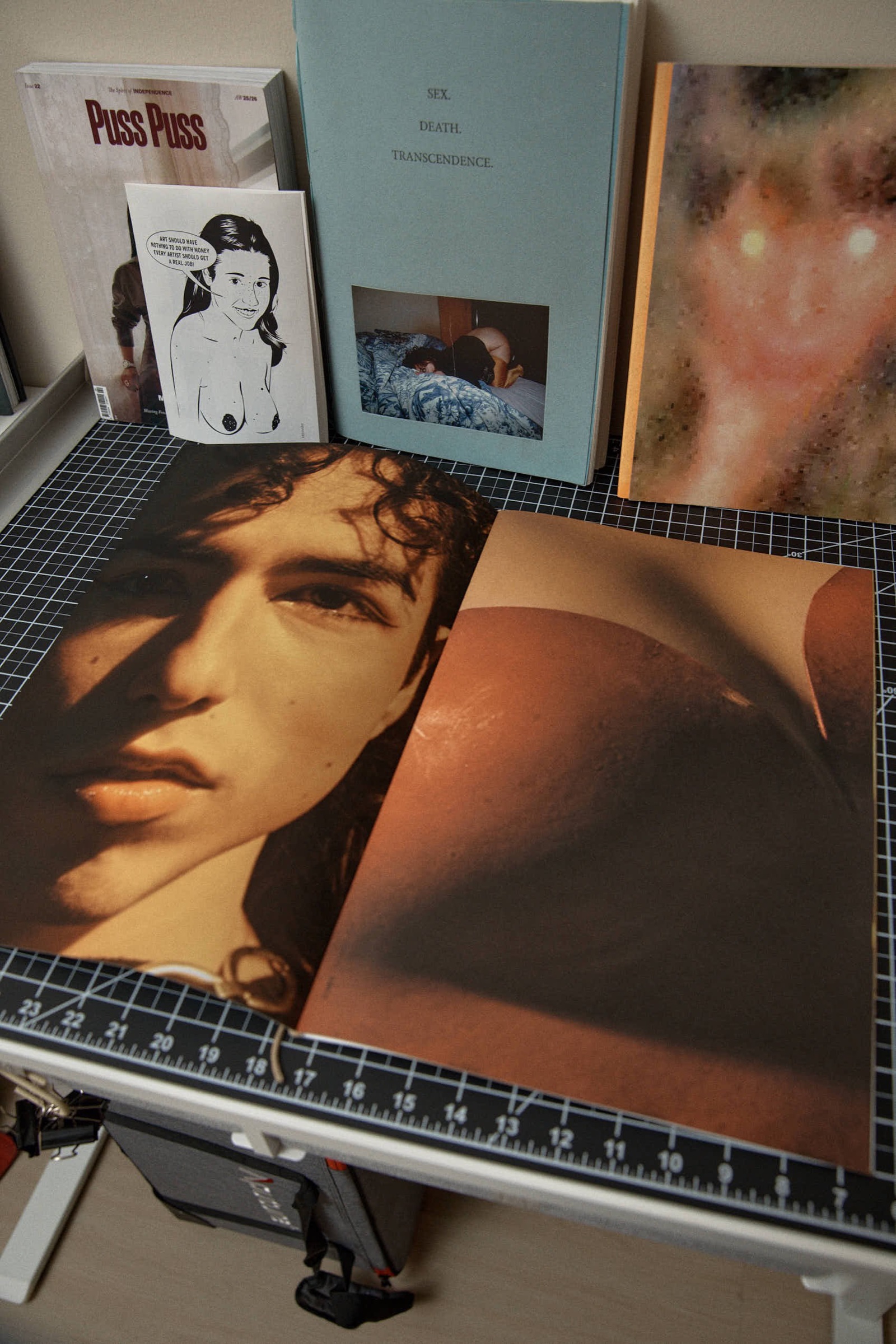 Open book spread, portrait and warm-toned nude torso