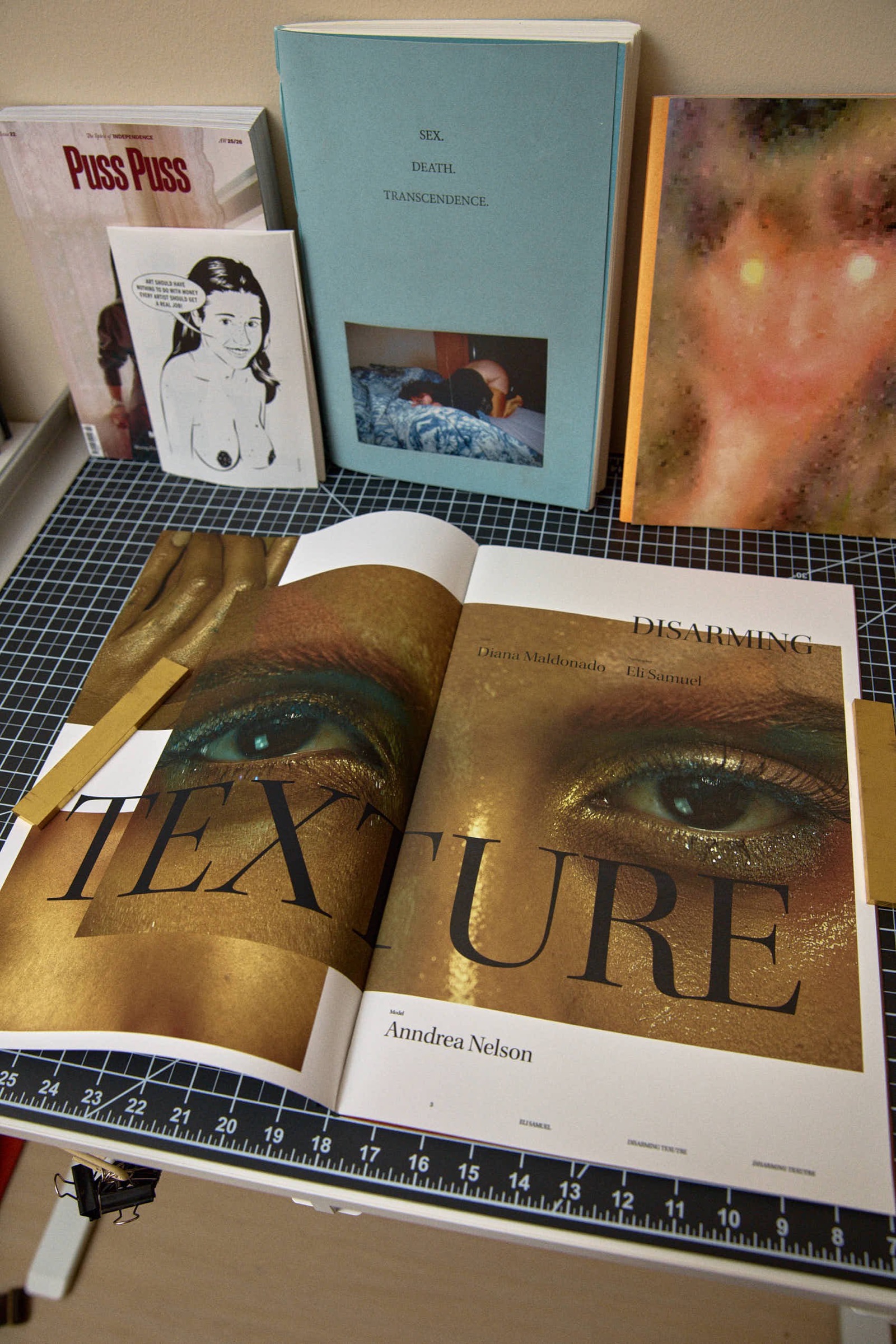 Open book spread, gold eye close-up and 'Texture' title page
