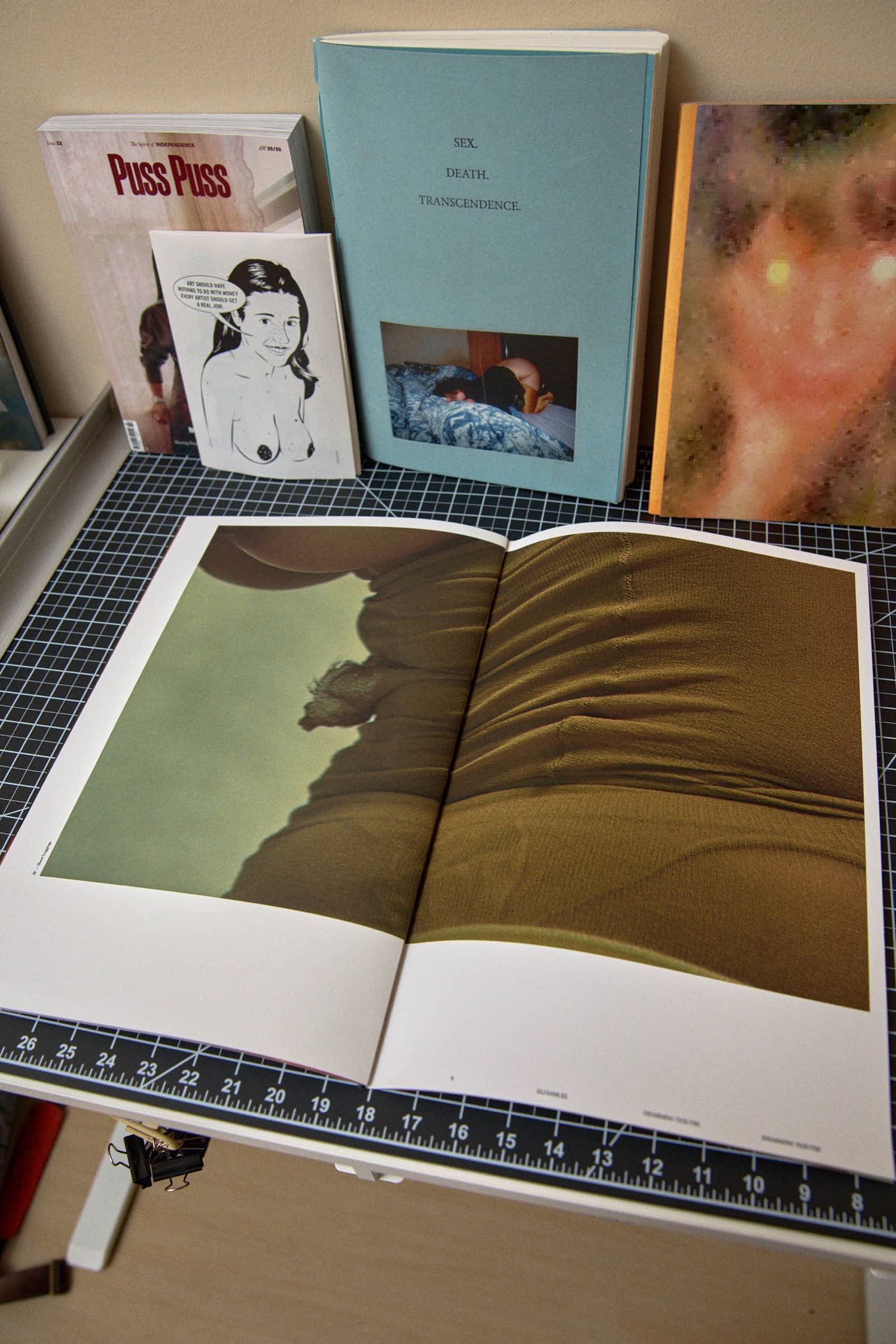 Open book spread, silhouette figure and draped fabric