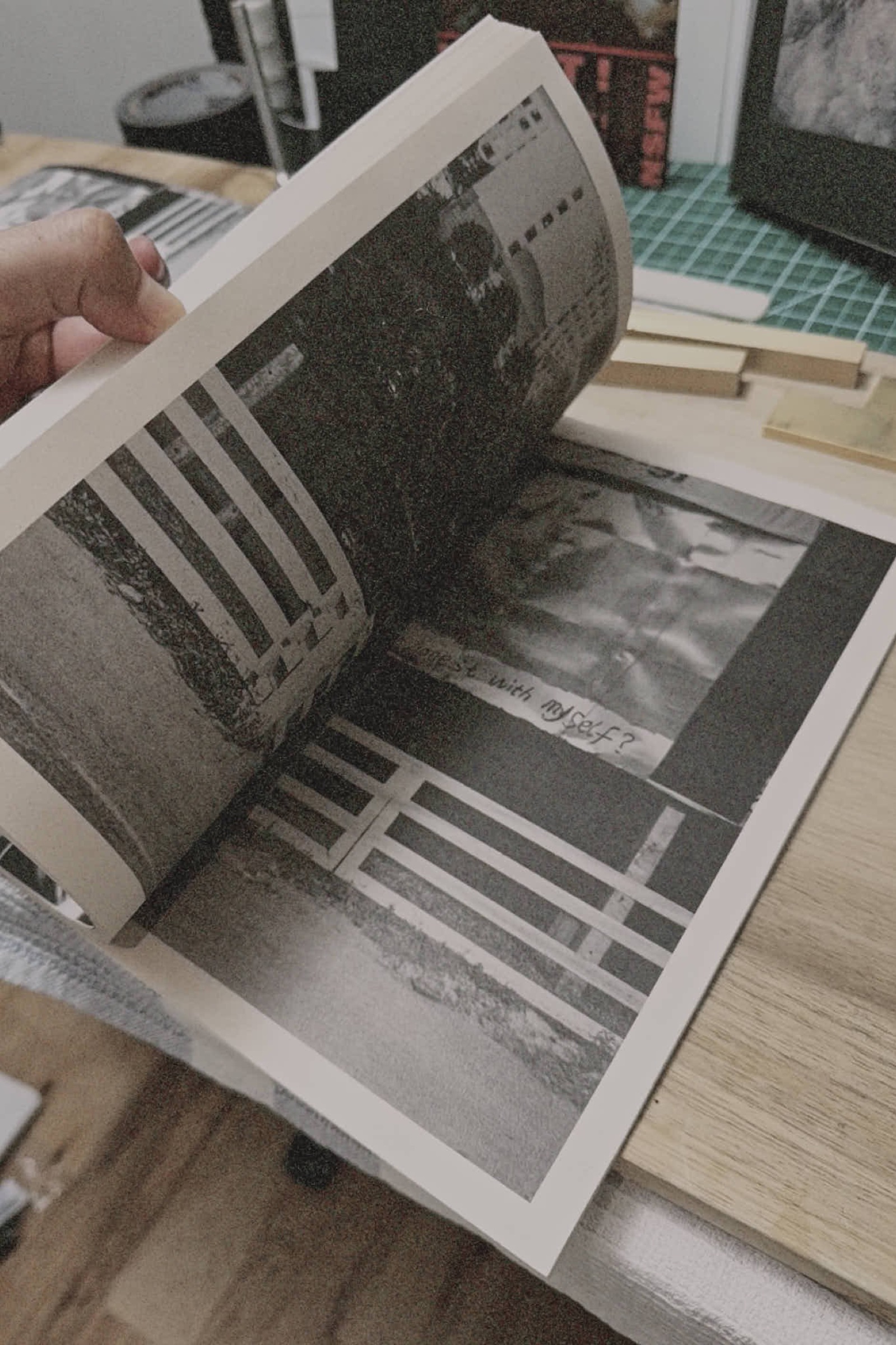 Open book spread, fence photograph and handwritten note