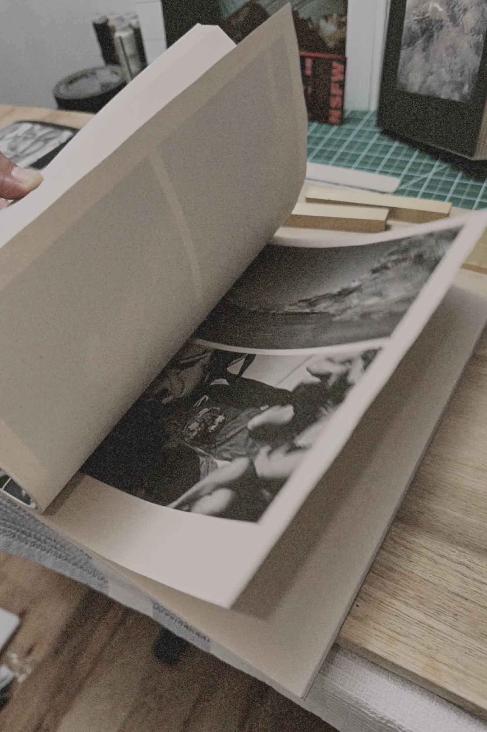 Open book spread, sky and hands photographs