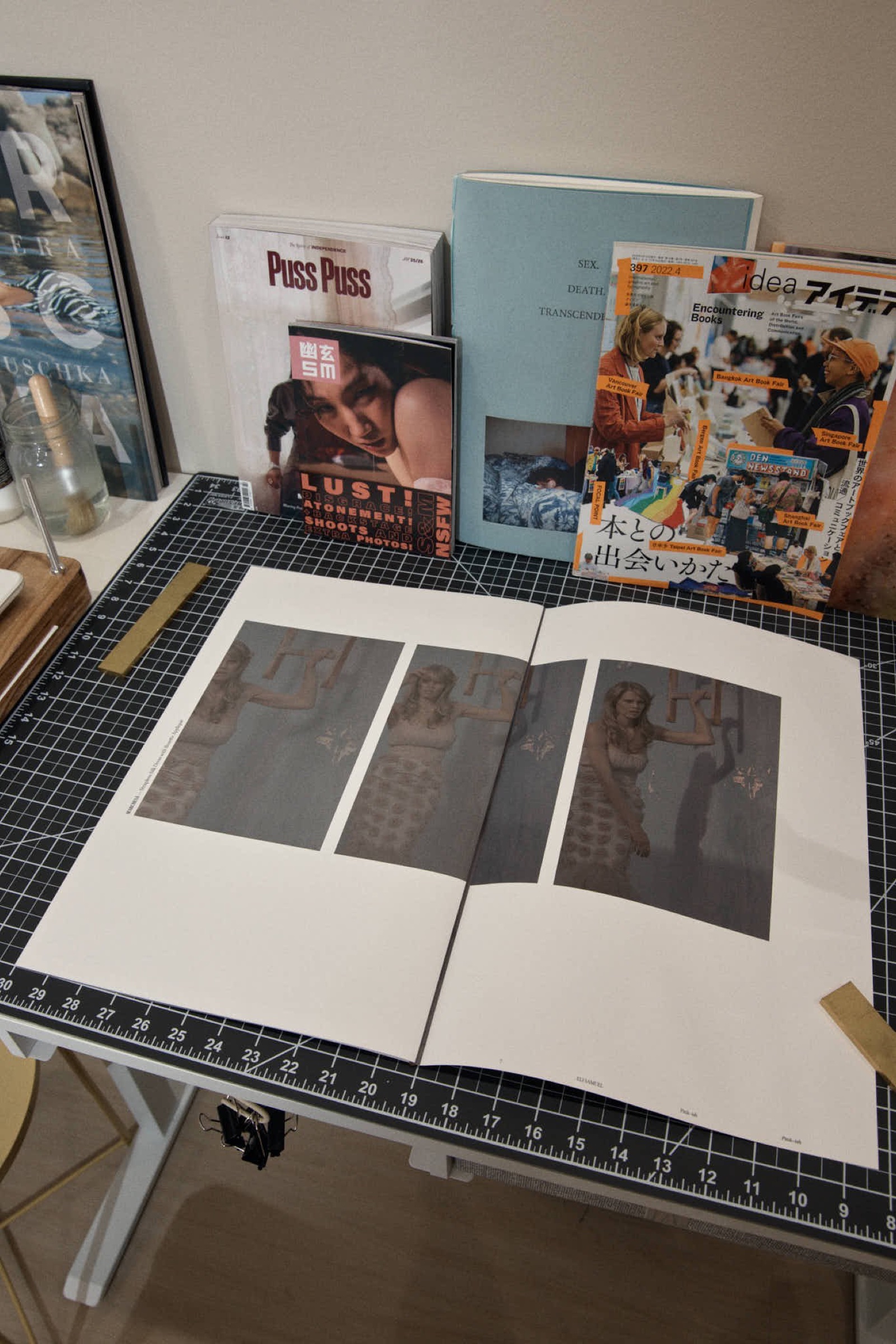 Open book spread, triptych of a woman by a slide