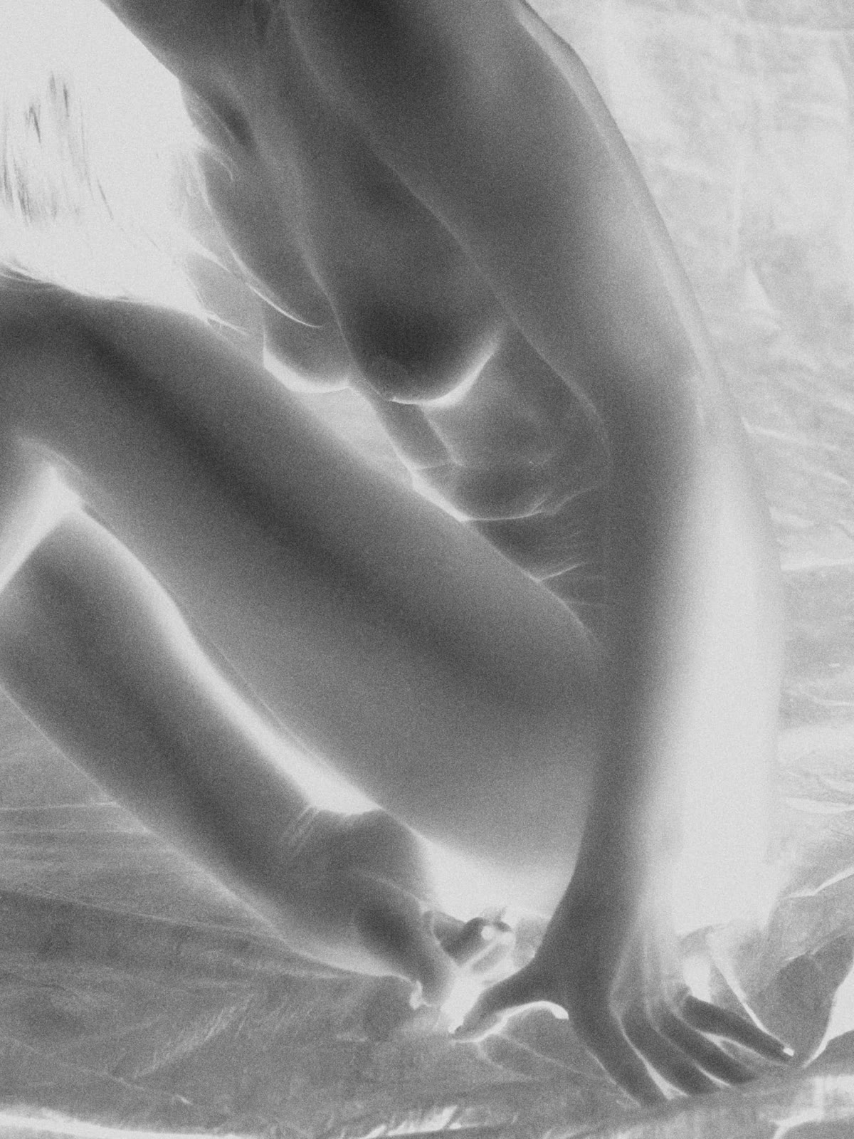 Film negative, bent knee and resting hand