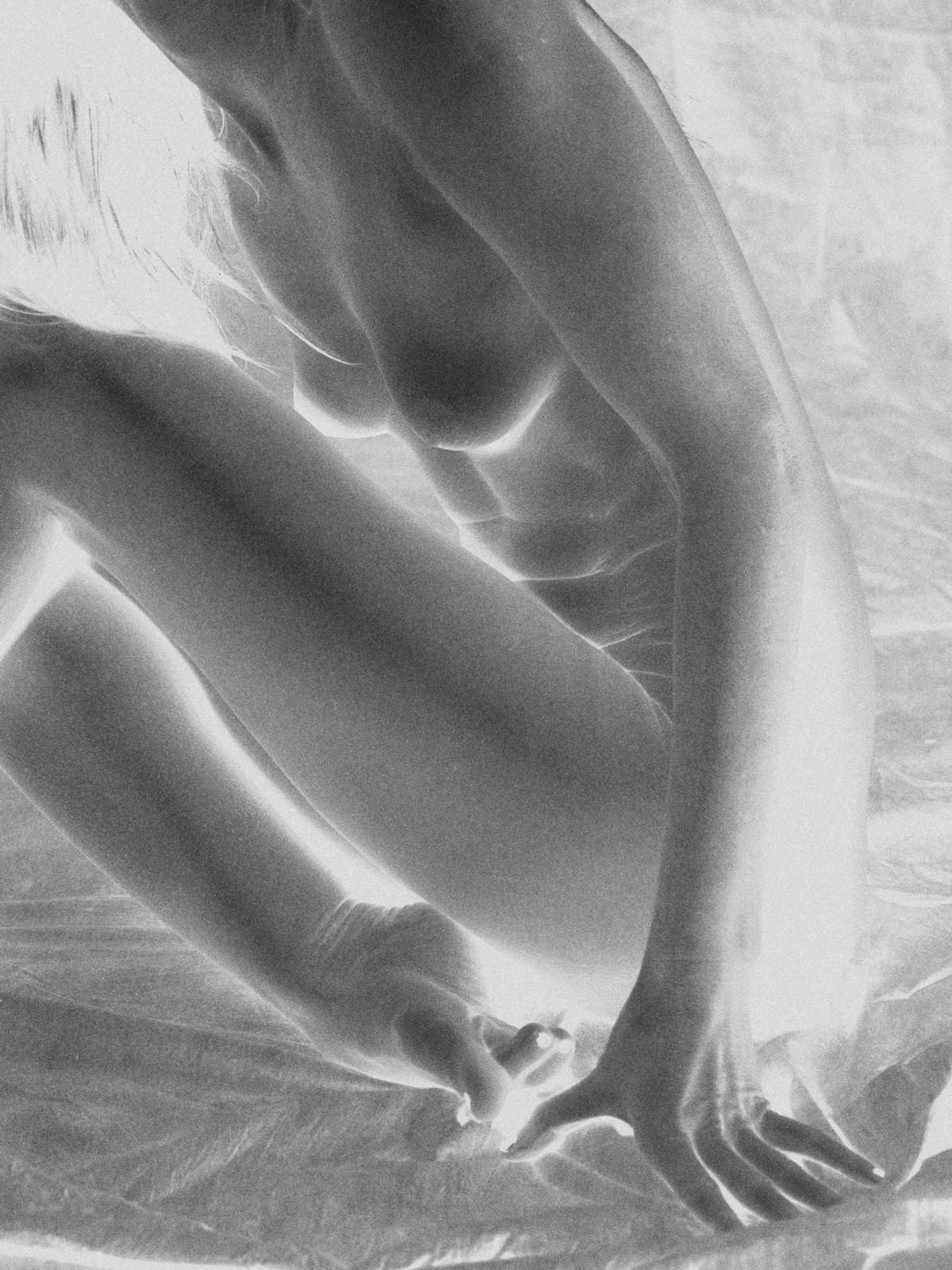 Film negative, bent knee and resting hand