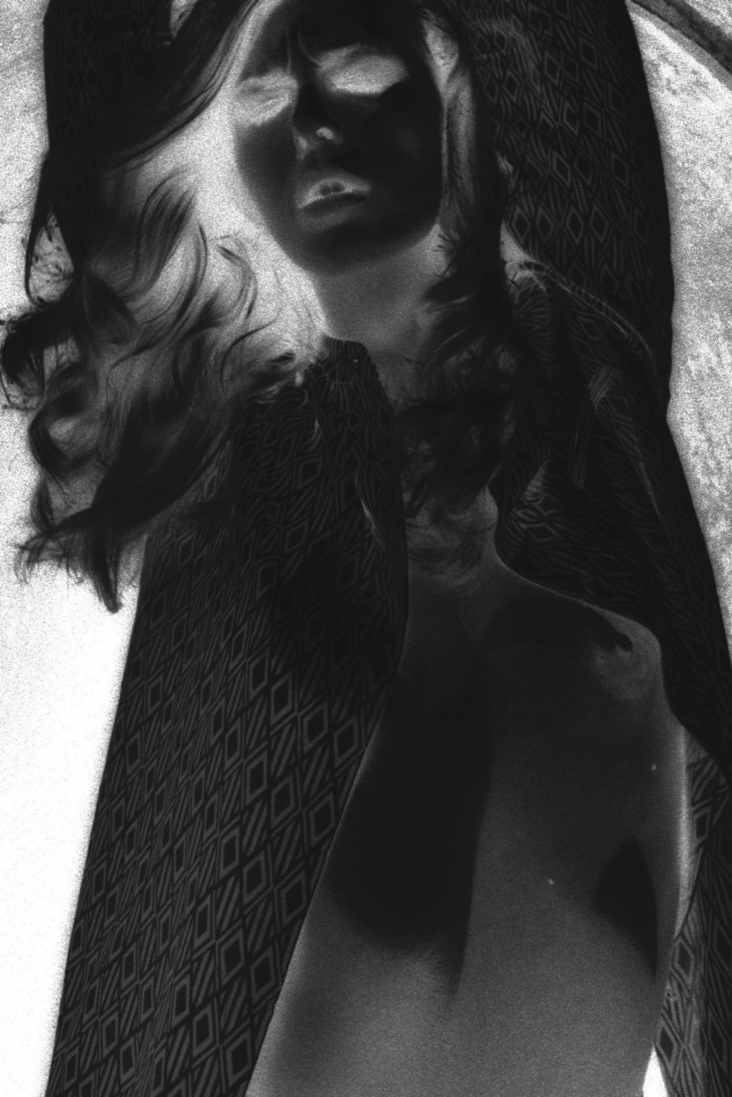Film negative, patterned wrap draped over shoulders