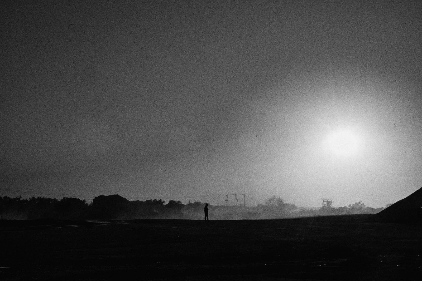 Jake Dyson silhouetted at dusk on the Ram Trucks set in a limestone quarry outside Austin, Texas, August 2026, photographed by Eli Samuel.