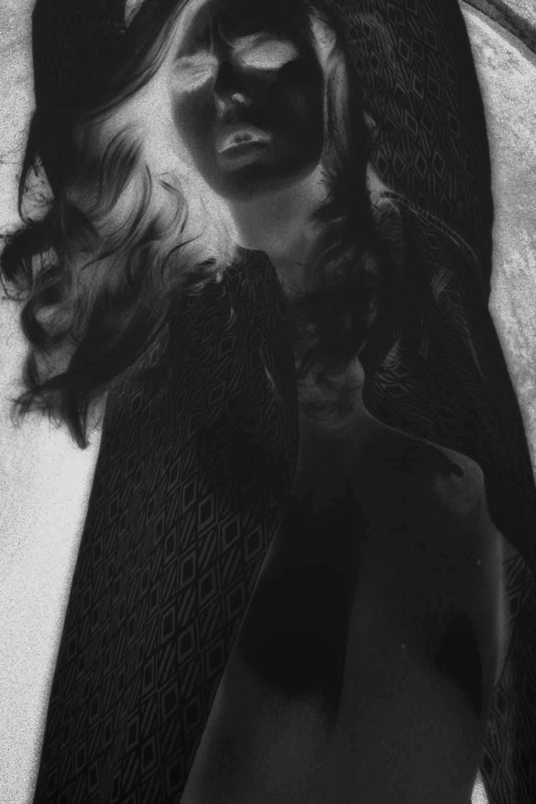 Film negative, patterned wrap draped over shoulders