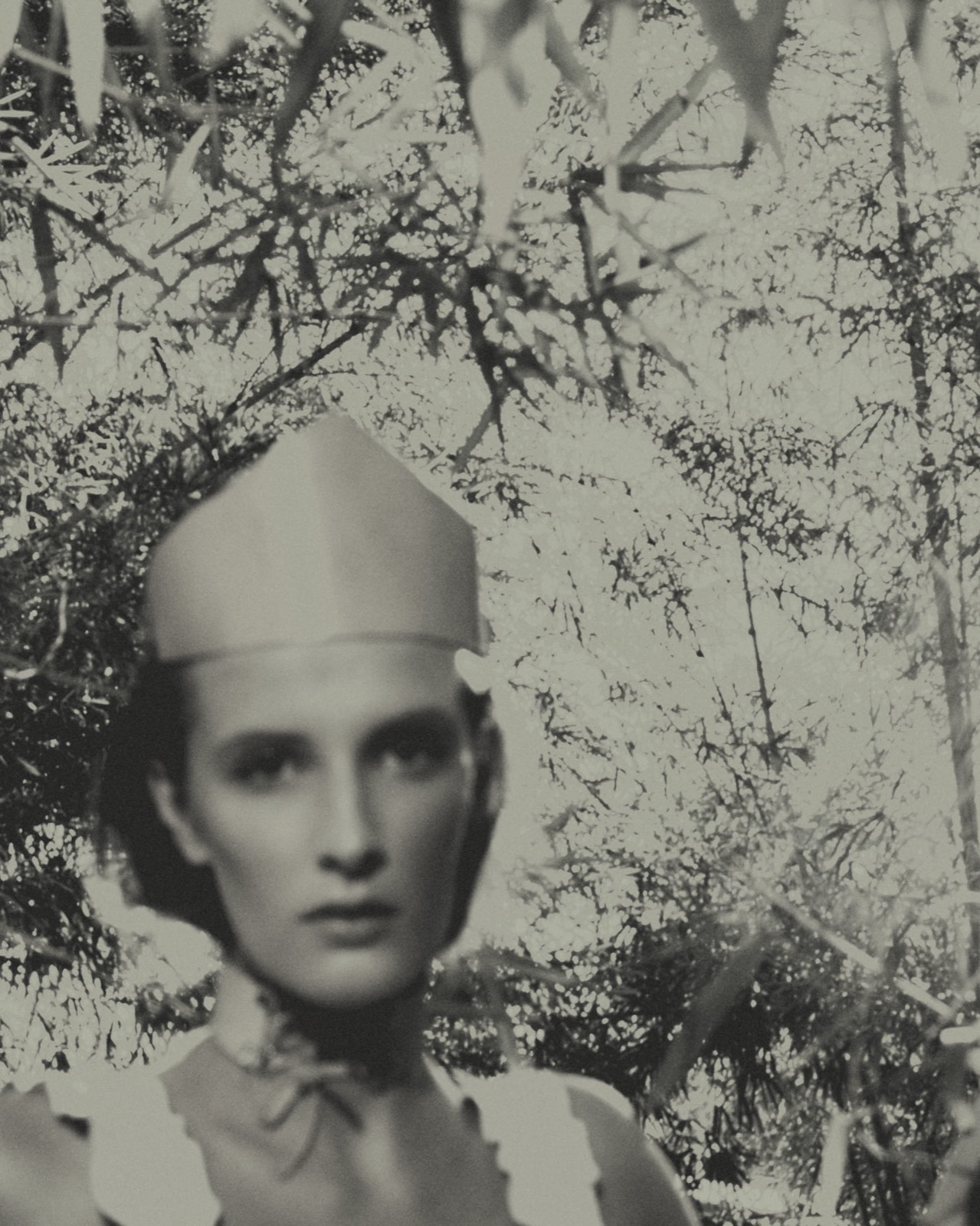 Model Sarah Moore in a pointed hood, double-exposed with tree branches, City Botanic Gardens, Brisbane, April 2017, photographed by Eli Samuel. Wardrobe styled by Josie O'Hanlon, make-up by Yasmine Dwyer, with Sarah Moore represented by Vivien's Model Management.